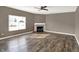 Cozy living room featuring a fireplace, ceiling fan, and large window providing natural light and comfort at 3529 Miesha Dr, Indianapolis, IN 46217