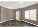 Neutral living room features hardwood floors, freshly painted walls, and bright window at 3529 Miesha Dr, Indianapolis, IN 46217