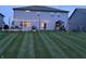 Beautiful backyard with lush lawn, play set, patio, and outdoor seating, perfect for Gathering fun and entertaining at 3650 Tipperlin Rd, Bargersville, IN 46106