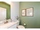 Stylish half bathroom featuring modern fixtures and fresh green walls at 3650 Tipperlin Rd, Bargersville, IN 46106