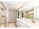 Bright bathroom with dual sinks, white cabinets, large mirror, and glass enclosed shower at 3650 Tipperlin Rd, Bargersville, IN 46106