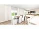 Bright dining area with wood table, white curtains, and view of backyard at 3650 Tipperlin Rd, Bargersville, IN 46106