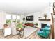Sunlit living room boasts a cozy fireplace, comfortable seating, and a view of the outdoors at 3650 Tipperlin Rd, Bargersville, IN 46106
