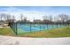 A fenced-in community pickleball court with blue and green surface and surrounding houses at 3650 Tipperlin Rd, Bargersville, IN 46106