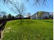 A sprawling green backyard is enclosed by a wooden fence, providing a private outdoor space at 3730 Cheyenne Ct, Columbus, IN 47203