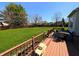View of deck, table and chairs with lovely lush green backyard at 3730 Cheyenne Ct, Columbus, IN 47203