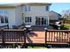 Back of home and deck and lovely backyard with wood fence at 3730 Cheyenne Ct, Columbus, IN 47203