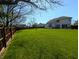 Fenced backyard features a large grassy area, ideal for outdoor activities and entertaining at 3730 Cheyenne Ct, Columbus, IN 47203