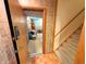 Basement entry from the stairwell, featuring tiled walls and floors for easy maintenance at 3730 Cheyenne Ct, Columbus, IN 47203