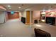 Finished basement with carpet, partial brick wall accent, and potential for home theater at 3730 Cheyenne Ct, Columbus, IN 47203