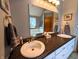 Bathroom featuring double sinks with gold fixtures and a granite countertop at 3730 Cheyenne Ct, Columbus, IN 47203