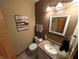 Neutral colored bathroom featuring a granite countertop and motivational wall art at 3730 Cheyenne Ct, Columbus, IN 47203