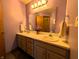 Elegant bathroom with double sinks, neutral cabinets, and a large mirror, offering a practical design at 3730 Cheyenne Ct, Columbus, IN 47203