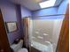 Cozy bathroom featuring a skylight, shower, and toilet, designed for functionality and comfort at 3730 Cheyenne Ct, Columbus, IN 47203