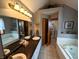 Bathroom boasting double sinks, a granite countertop, and a large mirror at 3730 Cheyenne Ct, Columbus, IN 47203