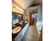 Spacious bathroom featuring double sinks, tiled floors, and a separate tub and shower at 3730 Cheyenne Ct, Columbus, IN 47203