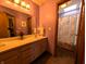 Bright bathroom with double sinks, a large mirror, and a view of the shower, creating a functional space at 3730 Cheyenne Ct, Columbus, IN 47203
