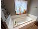 A luxurious bathtub with gold fixtures and a large window at 3730 Cheyenne Ct, Columbus, IN 47203