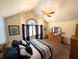 Bedroom featuring a ceiling fan, large windows, and a dresser with a mirror at 3730 Cheyenne Ct, Columbus, IN 47203