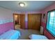 Cozy bedroom featuring twin beds, a window view, and ample closet space for a comfortable living at 3730 Cheyenne Ct, Columbus, IN 47203