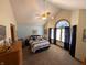 Spacious bedroom featuring a ceiling fan, vaulted ceiling, and large arched window at 3730 Cheyenne Ct, Columbus, IN 47203
