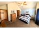 Carpeted bedroom with a ceiling fan, walk-in closet, and a light blue accent wall at 3730 Cheyenne Ct, Columbus, IN 47203