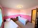 Bright bedroom with two twin beds and a wooden chest, creating a warm and inviting atmosphere at 3730 Cheyenne Ct, Columbus, IN 47203