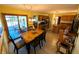 Warm dining area with a wooden table, chairs, and access to the deck, creating a inviting space for dining at 3730 Cheyenne Ct, Columbus, IN 47203