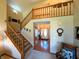 Bright foyer showcases a staircase, wooden railings, and inviting front door, creating a warm welcome at 3730 Cheyenne Ct, Columbus, IN 47203