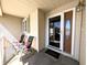 Welcoming front door with a glass insert and a covered porch with seating at 3730 Cheyenne Ct, Columbus, IN 47203