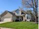 Charming two-story home with a well-manicured lawn and inviting front porch at 3730 Cheyenne Ct, Columbus, IN 47203