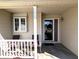 Inviting front porch with seating, offering a welcoming entry to the home at 3730 Cheyenne Ct, Columbus, IN 47203