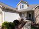 Inviting front porch featuring decorative landscaping and a cozy seating area at 3730 Cheyenne Ct, Columbus, IN 47203