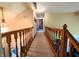 Hallway with carpeted floors, decorative chandelier and wooden railing at 3730 Cheyenne Ct, Columbus, IN 47203