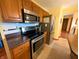 The kitchen features stainless steel appliances and wood cabinets at 3730 Cheyenne Ct, Columbus, IN 47203