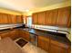 Well-lit kitchen with wood cabinets, stainless steel dishwasher and a kitchen window at 3730 Cheyenne Ct, Columbus, IN 47203