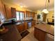 Bright kitchen features wood cabinets, tile backsplash, stainless steel appliances, and an island at 3730 Cheyenne Ct, Columbus, IN 47203