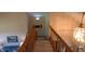 Carpeted stairway with wooden railing and decorative lighting at 3730 Cheyenne Ct, Columbus, IN 47203