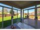 Enclosed sunroom offering serene views of the lush backyard and an expansive wooden deck at 3730 Cheyenne Ct, Columbus, IN 47203