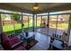 Inviting sunroom with tile floors, ceiling fan, and view of the backyard and deck at 3730 Cheyenne Ct, Columbus, IN 47203