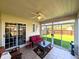 Bright sunroom with sliding glass doors offering a view of the well-maintained backyard at 3730 Cheyenne Ct, Columbus, IN 47203
