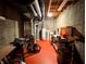 Utility room with painted red floor and exposed duct work and equipment at 3730 Cheyenne Ct, Columbus, IN 47203