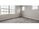 Bedroom featuring neutral gray walls, plush carpet, white trim, and plenty of natural light from multiple windows at 388 S Meridian Unit A-Bldg C St # A, Greenwood, IN 46142