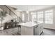 Bright kitchen island with pendant lighting, stainless steel appliances, and staircase in open concept living space at 388 S Meridian Unit A-Bldg C St # A, Greenwood, IN 46142