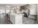 An open concept kitchen and living area with modern features like an island, stainless appliances, and staircase at 388 S Meridian Unit A-Bldg C St # A, Greenwood, IN 46142