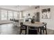 Modern kitchen boasts stainless steel appliances, white cabinetry, and island with seating adjacent to dining area at 388 S Meridian Unit A-Bldg C St # A, Greenwood, IN 46142