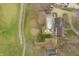 Aerial view showcases a backyard with an in-ground pool, a covered patio, and a playground at 3892 Arrowhead Ct, Greenfield, IN 46140