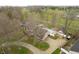 Aerial shot showcases the home with a large pool, garage, and spacious grounds at 3892 Arrowhead Ct, Greenfield, IN 46140