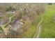 Estate with spacious backyard including a pool, and lush landscaping, captured from an aerial view at 3892 Arrowhead Ct, Greenfield, IN 46140