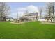 Expansive backyard featuring lush green grass, mature trees, and play structures at 3892 Arrowhead Ct, Greenfield, IN 46140